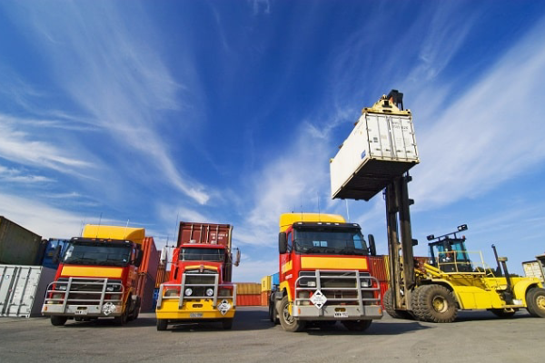 Fleet of MSLC trucks parked under cloudy skies ready for nationwide transportation operations.