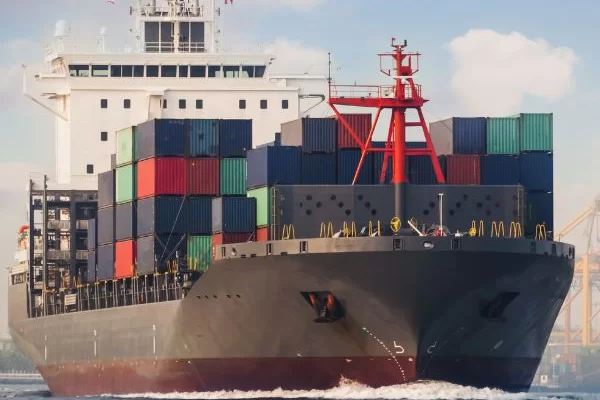 Large container ship transporting cargo across calm waters for MSLC integrated logistics solutions.